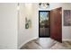 Elegant foyer with tile floors, decorative lighting, and an open doorway leading to an outdoor space at 3045 W Feather Sound Dr, Anthem, AZ 85086