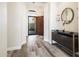 Elegant entryway with stylish console, decorative mirror, chandelier and a view to the front door at 3045 W Feather Sound Dr, Anthem, AZ 85086
