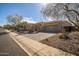 Beautiful home exterior with a well-manicured yard, desert landscaping, and a paver driveway at 3045 W Feather Sound Dr, Anthem, AZ 85086