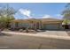 Charming desert home featuring stone accents, mature landscaping, and a paver driveway at 3045 W Feather Sound Dr, Anthem, AZ 85086