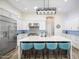 Modern kitchen featuring a large island with seating, white cabinets, stainless steel appliances, and stylish backsplash at 3045 W Feather Sound Dr, Anthem, AZ 85086