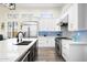 Beautiful kitchen featuring white cabinets, stainless steel appliances, a large island, and a black sink at 3045 W Feather Sound Dr, Anthem, AZ 85086