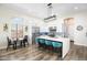 Bright kitchen showcasing a large island with seating, white cabinets, stainless steel appliances, and modern pendant lighting at 3045 W Feather Sound Dr, Anthem, AZ 85086