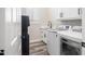 Well-organized laundry room with modern appliances, ample counter space, and custom cabinetry at 3045 W Feather Sound Dr, Anthem, AZ 85086