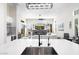 Open concept living area with modern fireplace, plush seating, and a view to the outdoor space at 3045 W Feather Sound Dr, Anthem, AZ 85086
