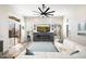 Open concept living room with modern fireplace, large windows, and comfortable seating area at 3045 W Feather Sound Dr, Anthem, AZ 85086
