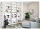 Bright and airy living room with bookshelves, modern decor, and cozy seating area at 3045 W Feather Sound Dr, Anthem, AZ 85086