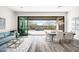 Open-concept living and dining area with large sliding doors to the outdoor patio and desert views at 3045 W Feather Sound Dr, Anthem, AZ 85086