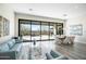 Spacious open concept living room with an adjacent dining area and patio access at 3045 W Feather Sound Dr, Anthem, AZ 85086