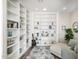 Bright living room featuring built-in bookshelves, recessed lighting, and stylish decor at 3045 W Feather Sound Dr, Anthem, AZ 85086