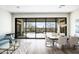 Open-plan living and dining room featuring a large glass sliding door to the patio at 3045 W Feather Sound Dr, Anthem, AZ 85086