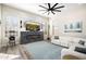 Bright living room with cozy seating, modern fireplace, and large windows offering scenic views at 3045 W Feather Sound Dr, Anthem, AZ 85086