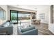 Bright living room with modern furnishings and an open view to the patio and desert landscape at 3045 W Feather Sound Dr, Anthem, AZ 85086