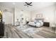 Spacious main bedroom featuring wood-look tile floors, neutral walls, and an en suite bathroom at 3045 W Feather Sound Dr, Anthem, AZ 85086