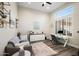 Bright office features a comfortable sitting area and workspace with natural light from a large window at 3045 W Feather Sound Dr, Anthem, AZ 85086