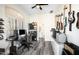 Well-lit music office with a ceiling fan, multiple guitars, workstation and wood-style tile flooring at 3045 W Feather Sound Dr, Anthem, AZ 85086