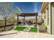Outdoor kitchen features a covered patio, built-in grill, dining set and low-maintenance landscaping at 3045 W Feather Sound Dr, Anthem, AZ 85086