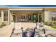 Elegant patio featuring lounge chairs and a peek into the home's open-concept dining and living areas at 3045 W Feather Sound Dr, Anthem, AZ 85086