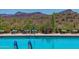 Inviting pool with lounge seating, providing a perfect spot to relax and enjoy the scenic mountain views at 3045 W Feather Sound Dr, Anthem, AZ 85086