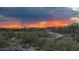 Expansive desert view with a dramatic sunset over a bridge and community homes at 3045 W Feather Sound Dr, Anthem, AZ 85086