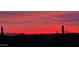 Vibrant sunset view over the desert landscape, casting a warm glow across the horizon at 3045 W Feather Sound Dr, Anthem, AZ 85086