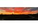 Scenic view of an Arizona sunset over the desert landscape and home exteriors at 3045 W Feather Sound Dr, Anthem, AZ 85086