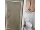 Compact bathroom featuring a shower stall, toilet, and overhead cabinet space at 3160 E Main St # 72, Mesa, AZ 85213