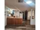 Kitchen with a peninsula countertop, ample cabinet space, and updated flooring at 3160 E Main St # 72, Mesa, AZ 85213