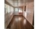 Bright sunroom featuring wood floors, multiple windows, and a door to the outside at 3160 E Main St # 72, Mesa, AZ 85213
