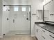 Modern bathroom featuring glass enclosed shower with gray tile and white vanity with black hardware at 3875 E Appaloosa Rd, Gilbert, AZ 85296