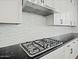 Up close view of kitchen gas range, custom tile backsplash, and stainless vent hood at 3875 E Appaloosa Rd, Gilbert, AZ 85296