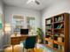 Bright home office with built-in bookcase, wooden desk, and large window at 3875 E Appaloosa Rd, Gilbert, AZ 85296