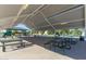 Covered picnic area with multiple tables and playground in the distance at 3875 E Appaloosa Rd, Gilbert, AZ 85296