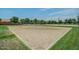 Sandy community volleyball court with net, basketball hoop, and playground nearby at 3875 E Appaloosa Rd, Gilbert, AZ 85296