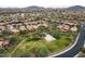 Aerial view showcasing residential neighborhood featuring a park and a basketball court at 42001 N Bridlewood Way, Phoenix, AZ 85086