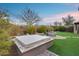 Beautiful backyard featuring a covered hot tub, desert landscaping, and an outdoor lounge at 42001 N Bridlewood Way, Phoenix, AZ 85086
