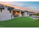 Resort style backyard with a covered patio, artificial turf, and a seating area with a firepit at 42001 N Bridlewood Way, Phoenix, AZ 85086