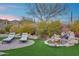 Inviting backyard featuring a small waterfall, lounge chairs, and desert landscaping at 42001 N Bridlewood Way, Phoenix, AZ 85086