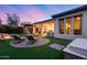 A picturesque backyard with a hot tub, lounge chairs, covered patio, and serene waterfall feature at 42001 N Bridlewood Way, Phoenix, AZ 85086
