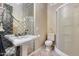 Stylish bathroom with mosaic tile wall, elegant sink, and glass-enclosed shower at 42001 N Bridlewood Way, Phoenix, AZ 85086