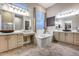 Traditional bathroom featuring granite countertops, dual vanities, soaking tub, and tile floors at 42001 N Bridlewood Way, Phoenix, AZ 85086