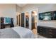 Modern bedroom boasts gray walls and wood floors, leading to walk-in closet, bath, and vanity at 42001 N Bridlewood Way, Phoenix, AZ 85086
