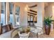 Bright breakfast nook features a round glass table, chandelier and cushioned seating with views to the outside at 42001 N Bridlewood Way, Phoenix, AZ 85086