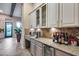 Butler pantry with glass cabinets, granite countertops, and wine storage for easy entertaining at 42001 N Bridlewood Way, Phoenix, AZ 85086