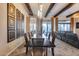 Elegant dining room with seating for six, modern light fixture, and wooden beams on the ceiling at 42001 N Bridlewood Way, Phoenix, AZ 85086