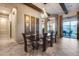 Elegant dining room with seating for six, modern light fixture, and wooden beams on the ceiling at 42001 N Bridlewood Way, Phoenix, AZ 85086