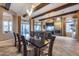Spacious dining room with coffered ceiling, fireplace, and an adjacent seating area for entertaining guests at 42001 N Bridlewood Way, Phoenix, AZ 85086