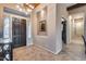 Welcoming foyer with dark wood door, tiled floors, decorative niche, and views into a closet at 42001 N Bridlewood Way, Phoenix, AZ 85086
