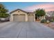 Charming single-story home featuring a three car garage and mature desert landscaping at 42001 N Bridlewood Way, Phoenix, AZ 85086