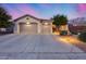 Charming single-story home showcasing a spacious driveway and a low maintenance desert landscape at 42001 N Bridlewood Way, Phoenix, AZ 85086